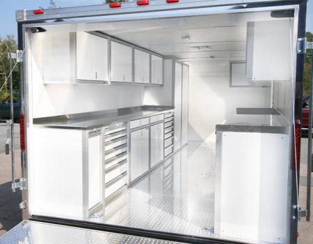 Trailer interior with white Pro II series storage cabinets on both sides