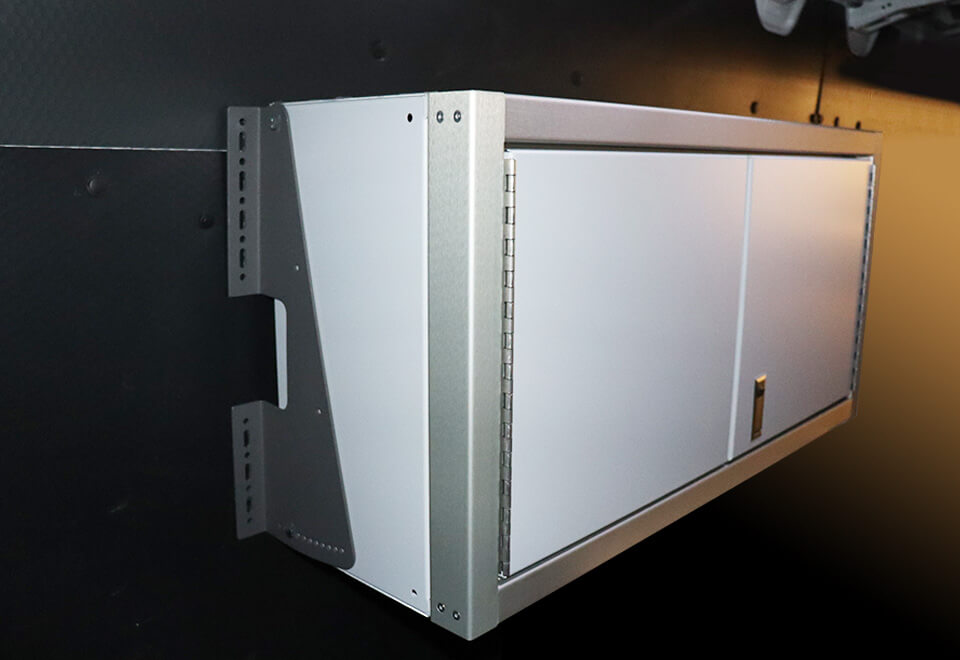 Wall cabinet mounted with angled wall brackets in a van
