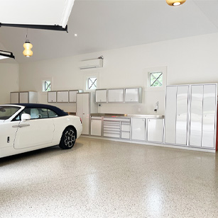residential garage with white car and white cabinets