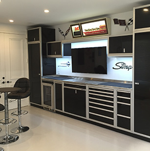 "Man cave" with black cabinets, seating area and flatscreen TV