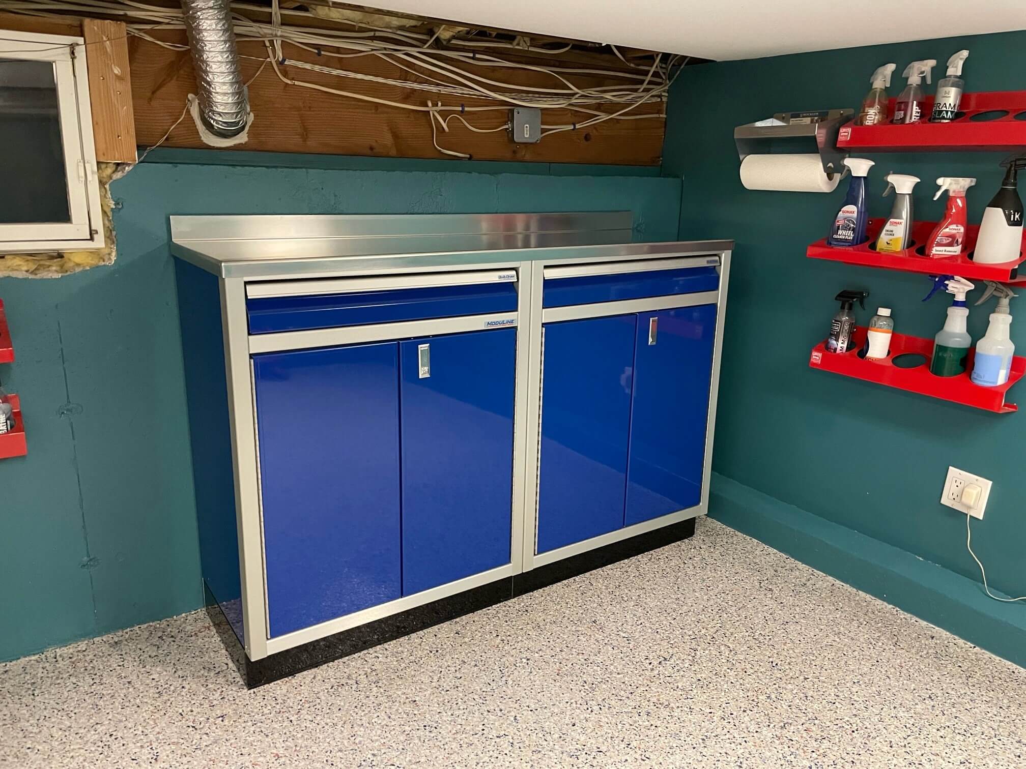Blue base cabinets with single drawers in basement with low ceiling