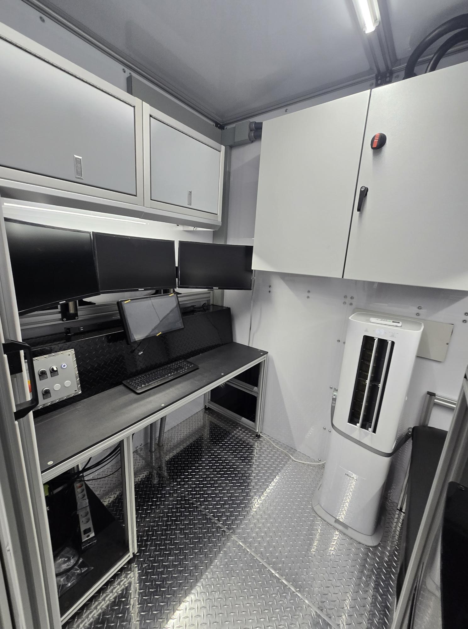 A mobile command center with gray Moduline aluminum cabinets for overhead storage